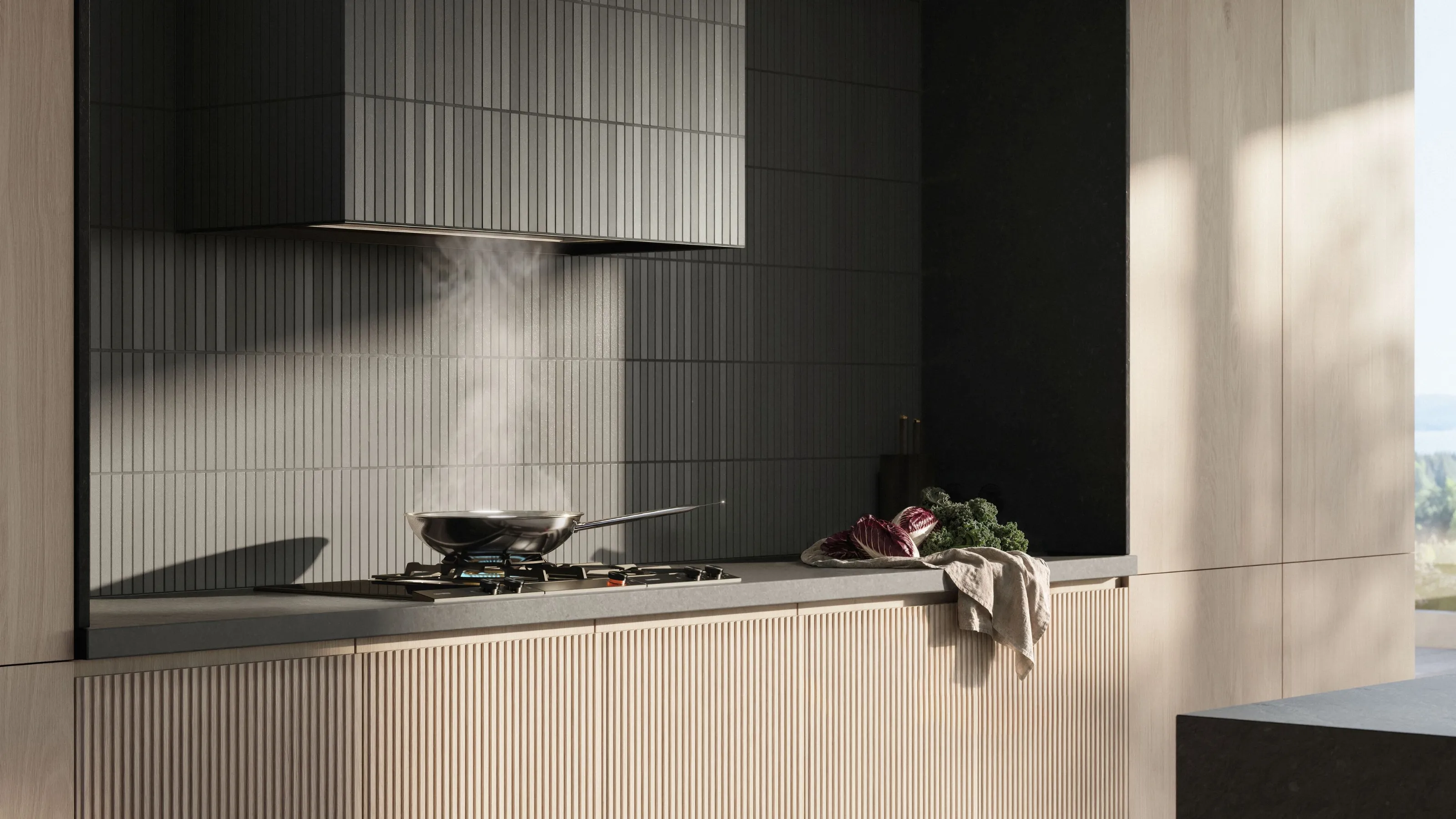 A Gaggenau telescopic hood above a gas cooktop in a modern kitchen