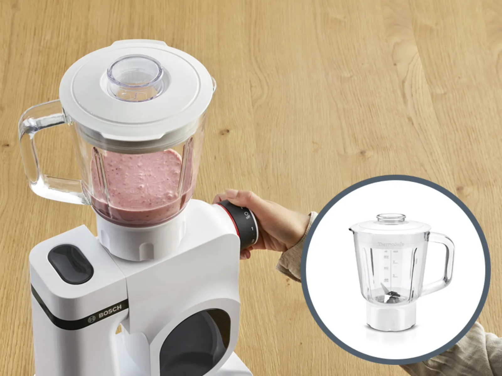 Blender with glass jar on wooden table, kitchen appliance for food preparation.