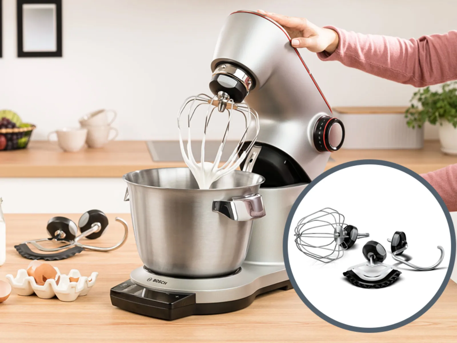 Kitchen counter with stand mixer, ingredients, and kitchen utensils. Close-up of stand mixer whisk attachment.