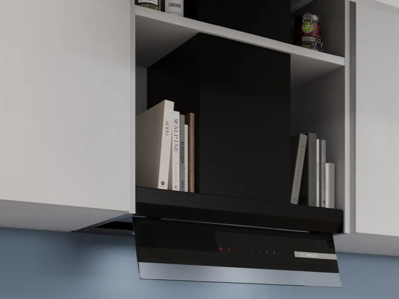 A modern kitchen range hood is installed between white cabinets and shelves holding books and a jar.