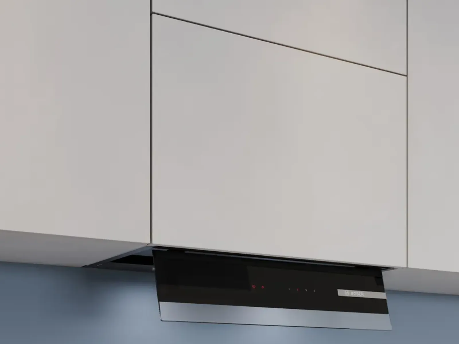 A built-in kitchen range hood with a black control panel is partially extended from white cabinetry against a blue wall.