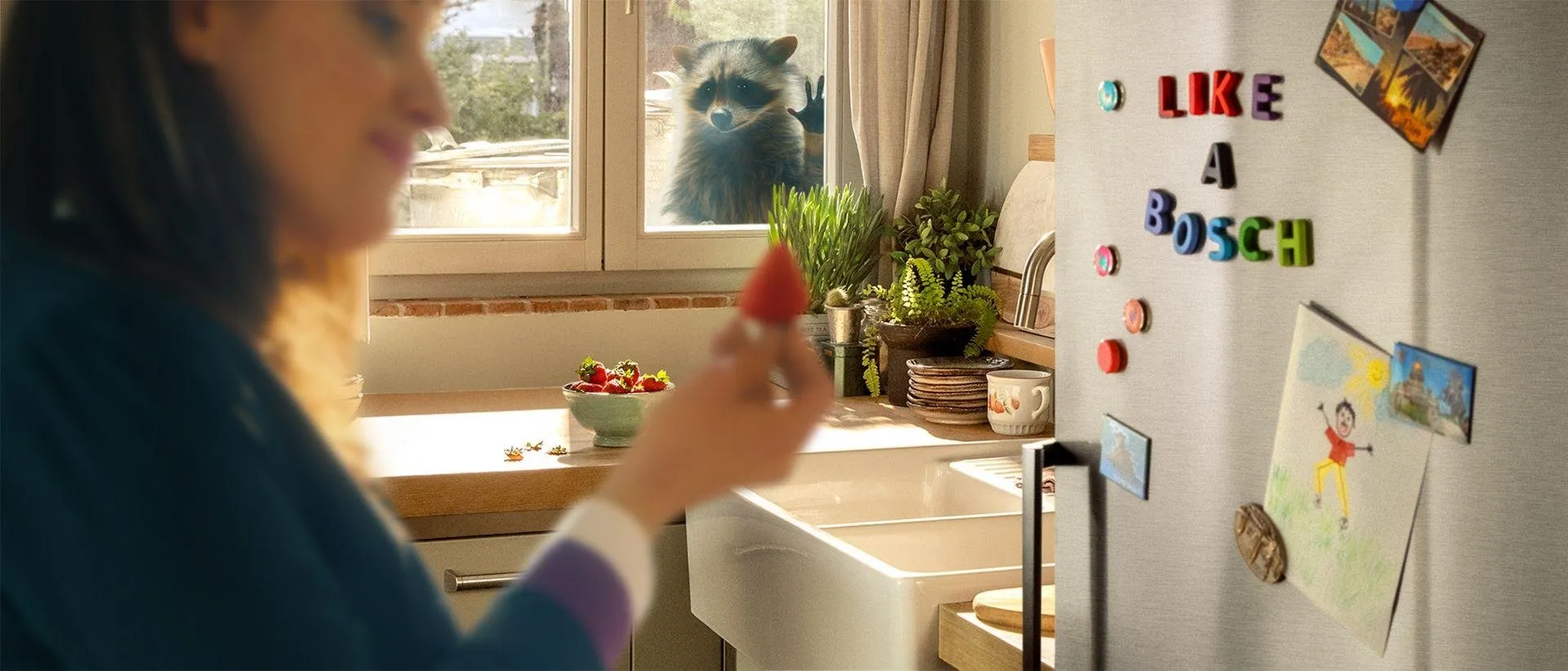 Woman in kitchen, plants, artwork, and "Like a boss" text on wall.