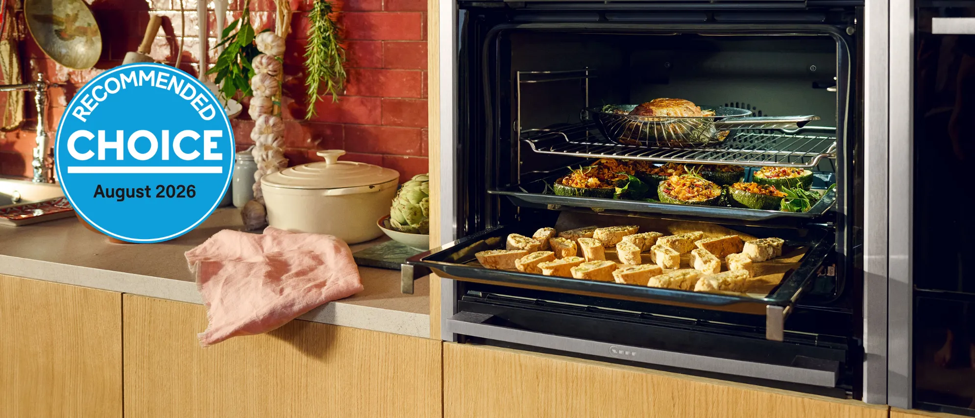 Two NEFF ovens in a kitchen with food cooking