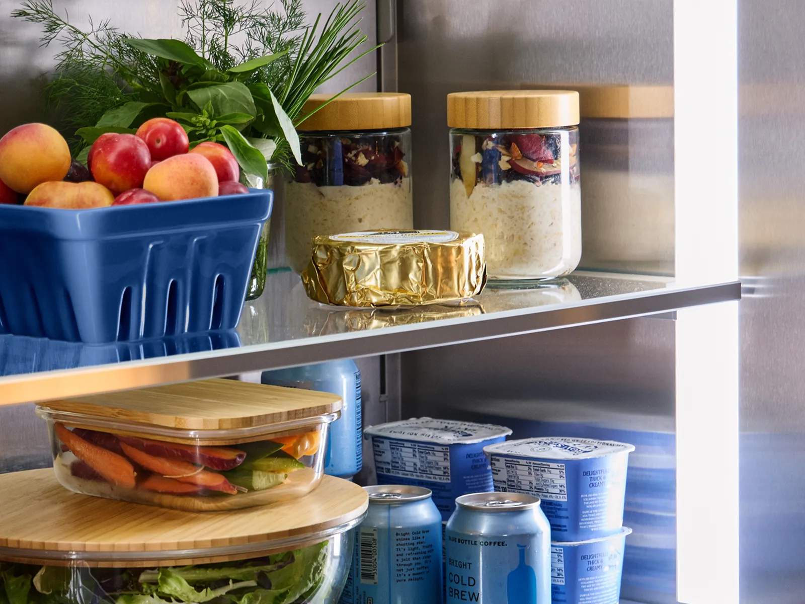 Thermador open refrigerator column filled with produce and drinks