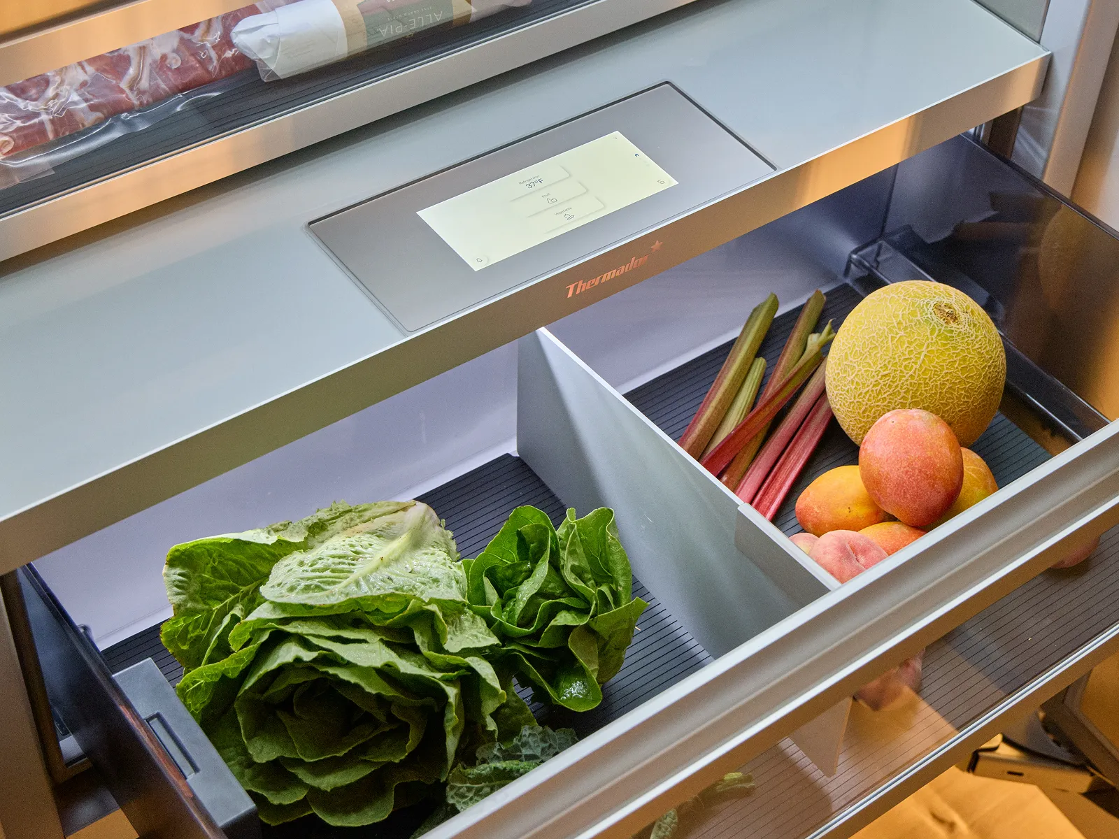 Open thermador refrigerator column with produce bin filled