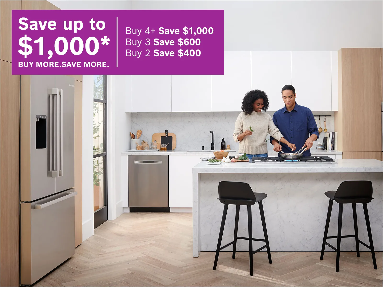 Couple cooking in a modern kitchen beside appliances, with a French promotion offering up to $1,000 in savings.