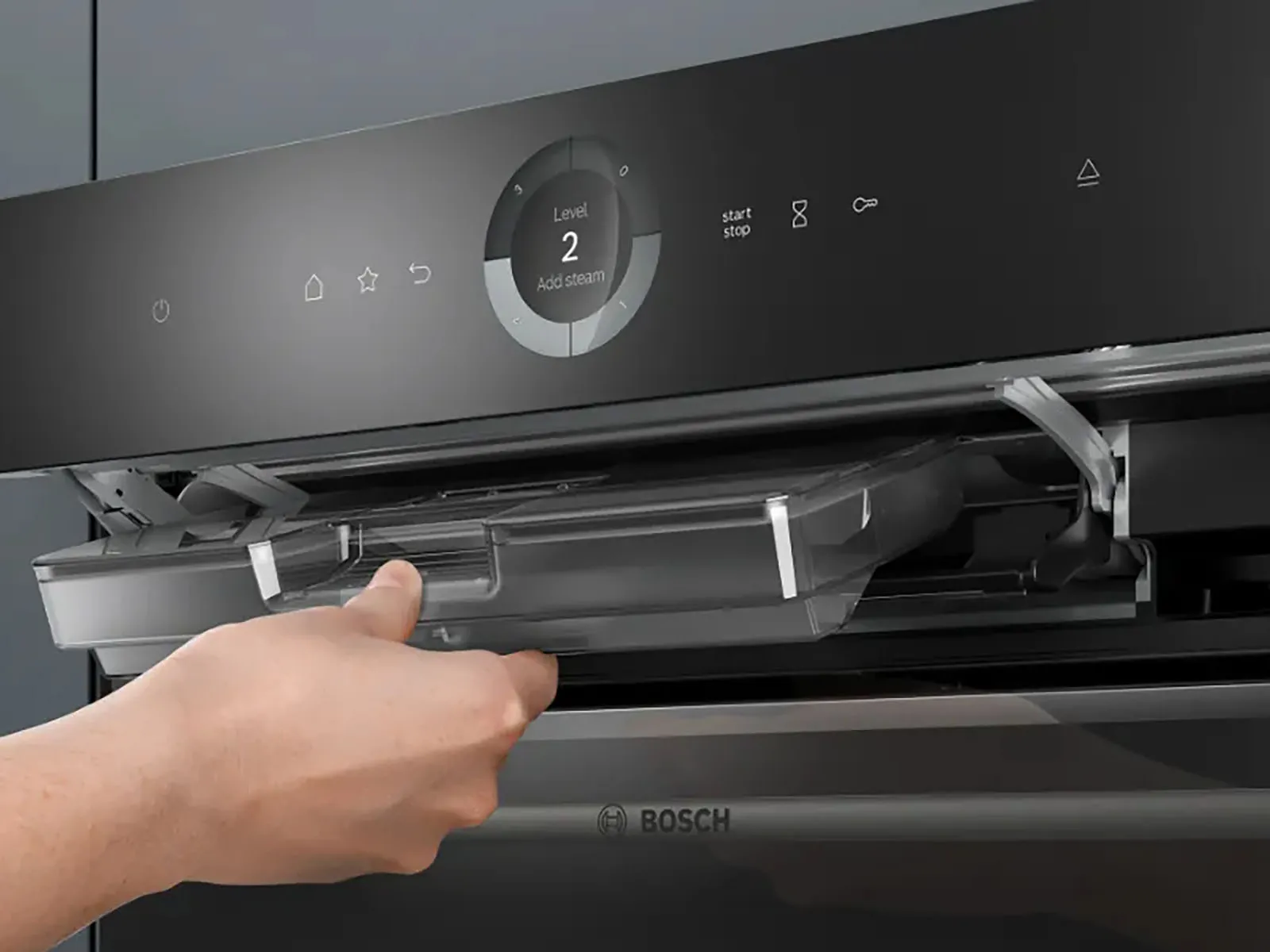 An open Bosch drawer reveals a stainless steel interior with a yellow sponge placed inside.