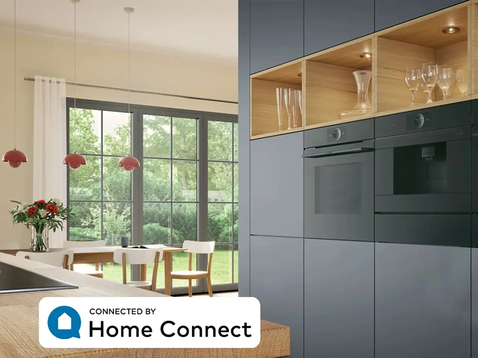 Elegant kitchen with built-in Series 8 built-in accent line electric oven and warming drawer. A tablet computer on the counter shows Bosch Home Connect App.
