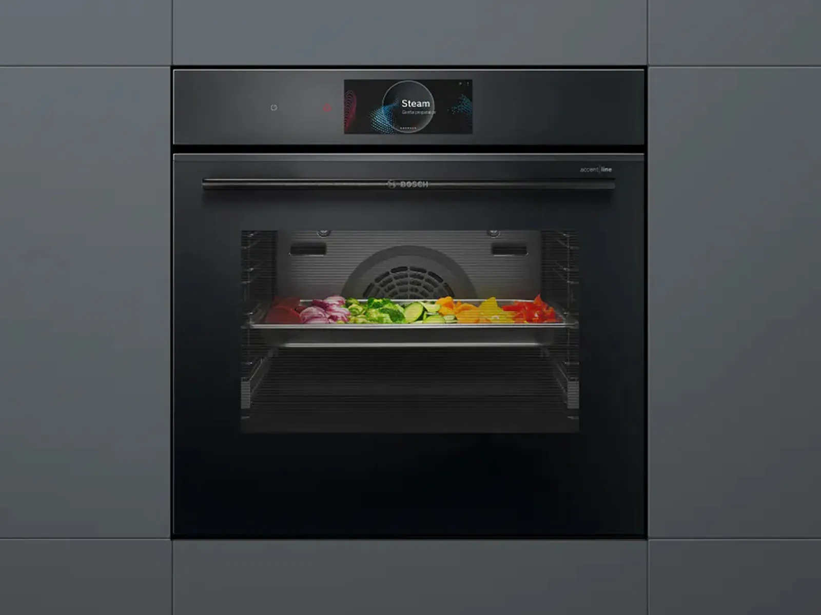 Bosch Series 8 accent line steam oven, in it is a baking tray with various vegetables.