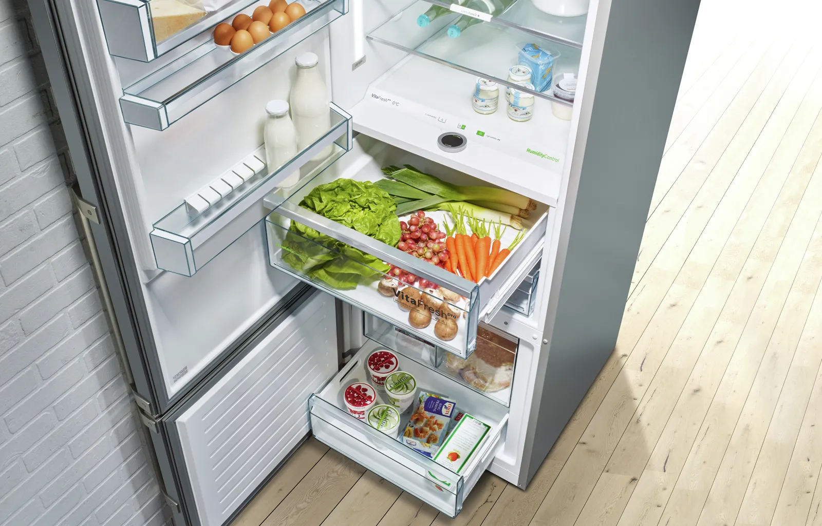 Open refrigerator with fresh vegetables, fruits, and dairy products neatly organized on shelves.