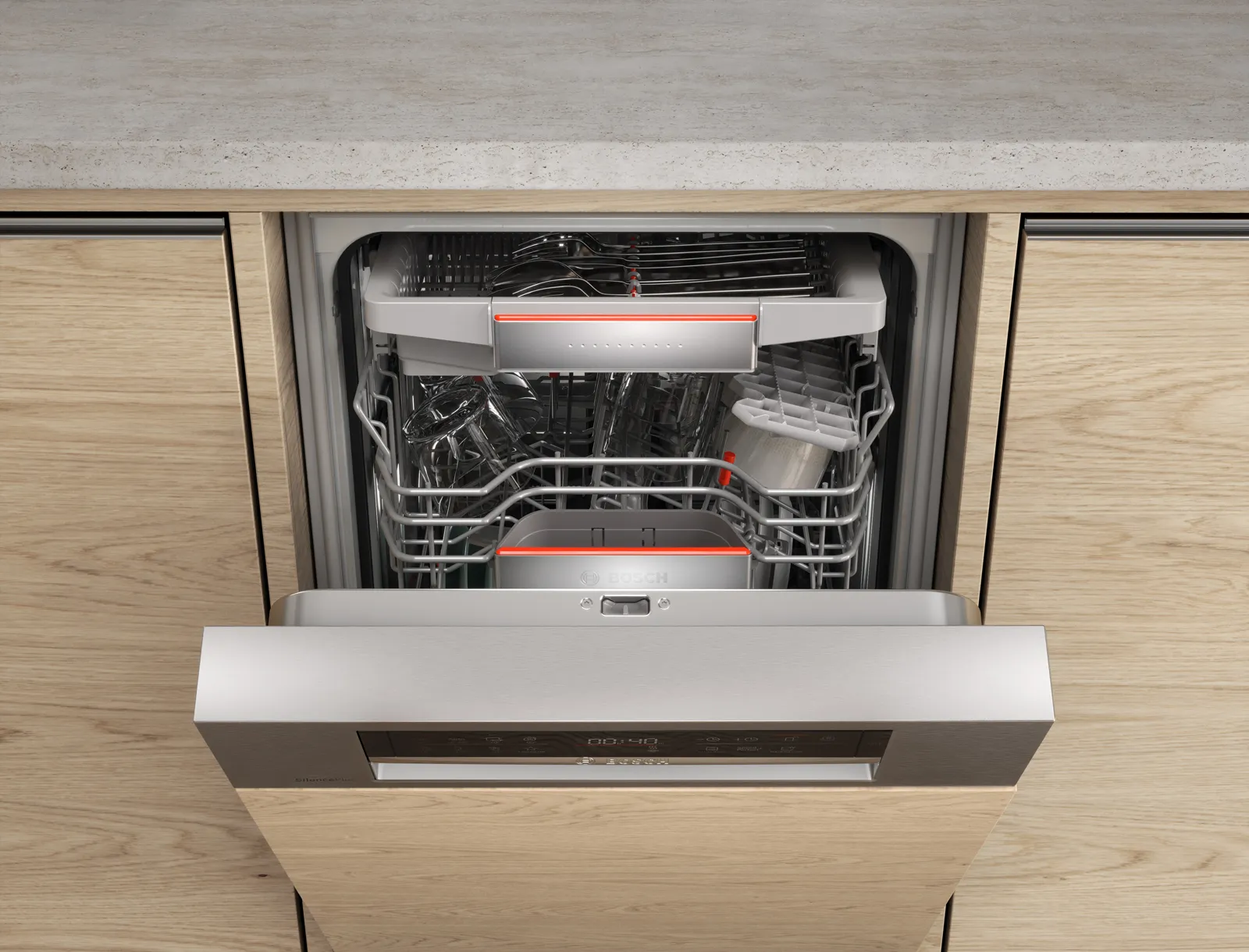 Open Bosch dishwasher integrated into wooden cabinetry with visible front controls.