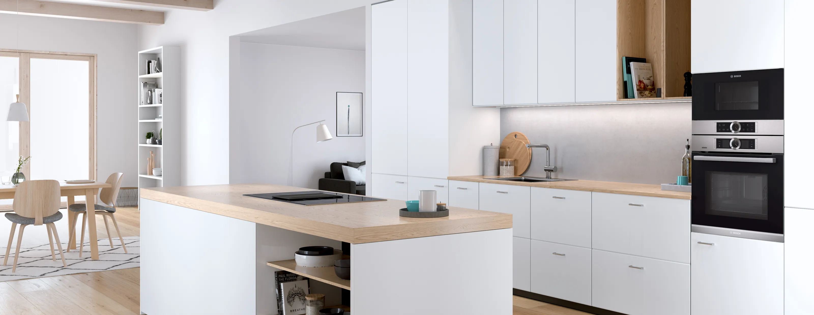 Built-in Bosch microwave seamlessly integrated on top of an oven into a modern white and wood kitchen design.