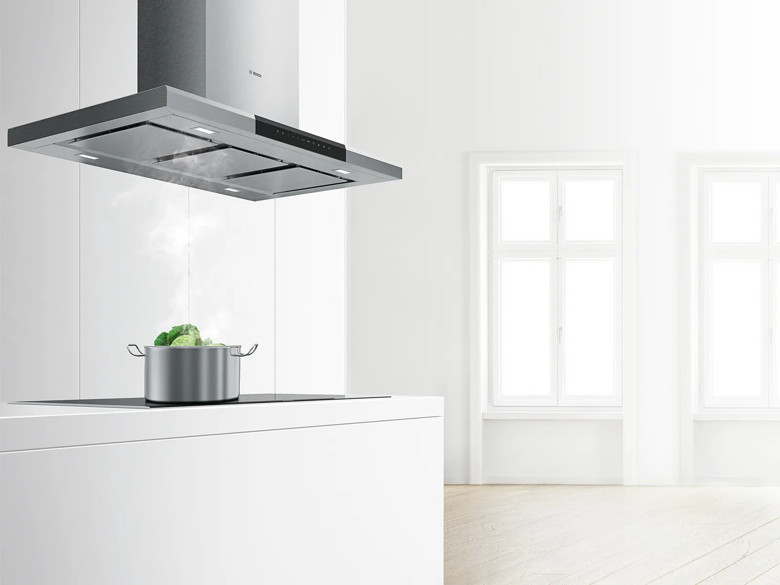 Modern kitchen with white cabinets, stainless steel range hood, and a pot on the counter.