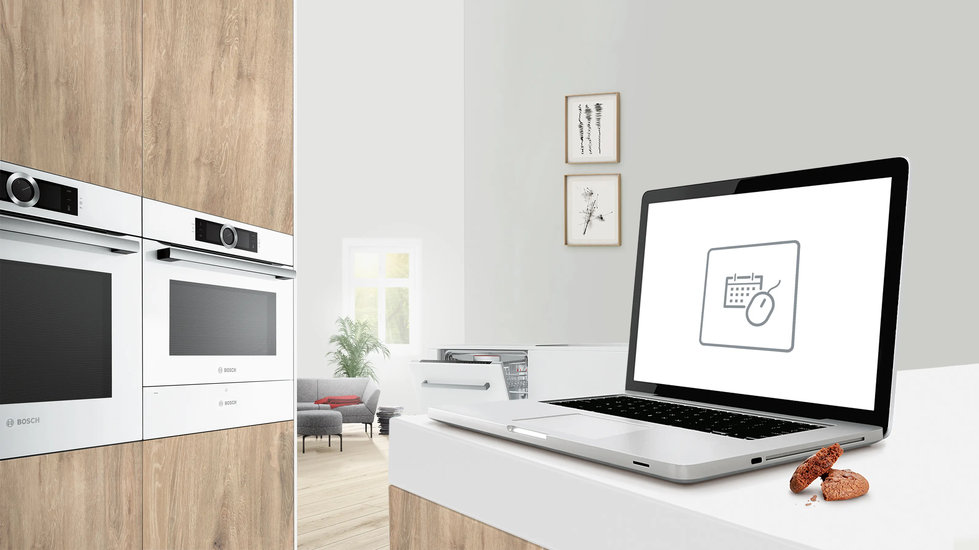 Modern kitchen with laptop, appliances, and decor in minimalist style.