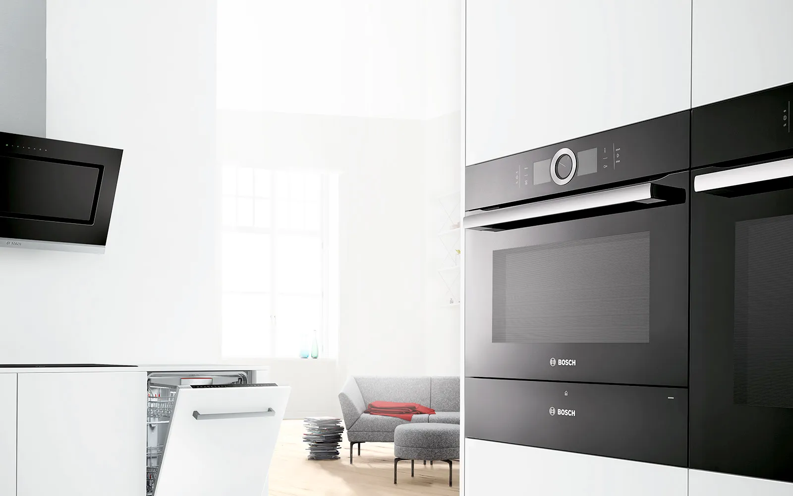 Moderne Küche mit eingebautem Backofen, Geschirrspüler und minimalistischen Möbeln im Hintergrund.