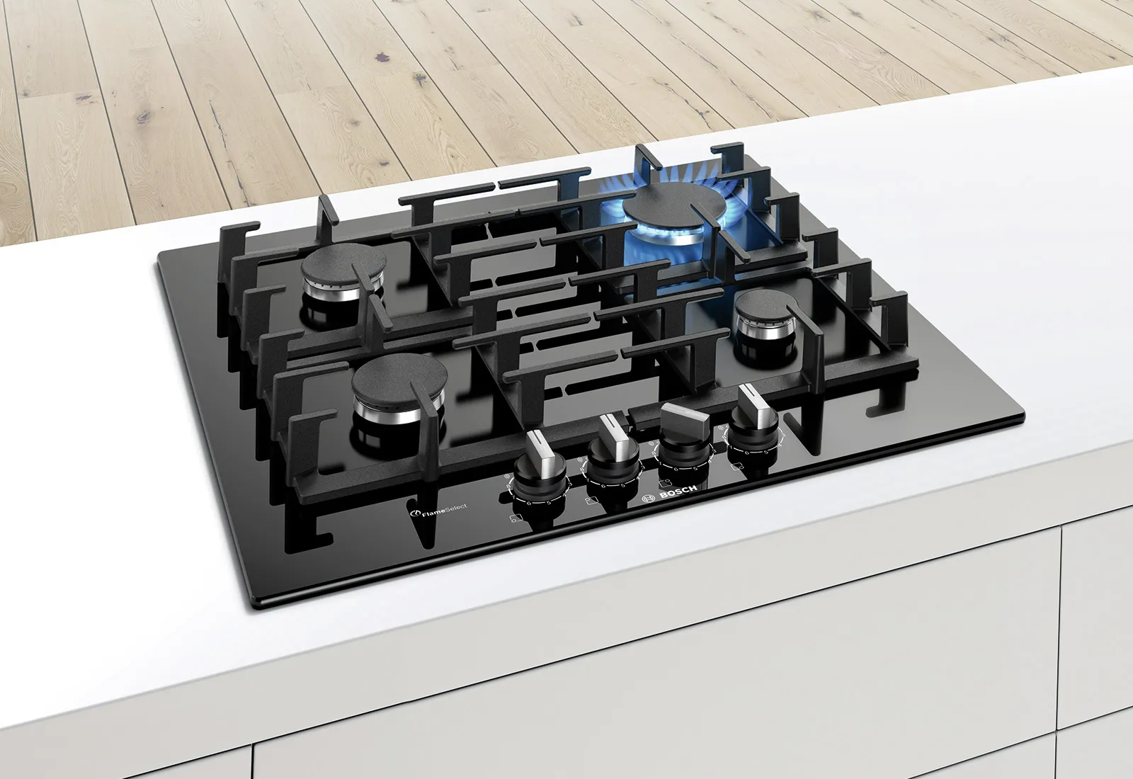 Modern black gas cooktop with five burners, one ignited with blue flame, set on a sleek white countertop with wood flooring.