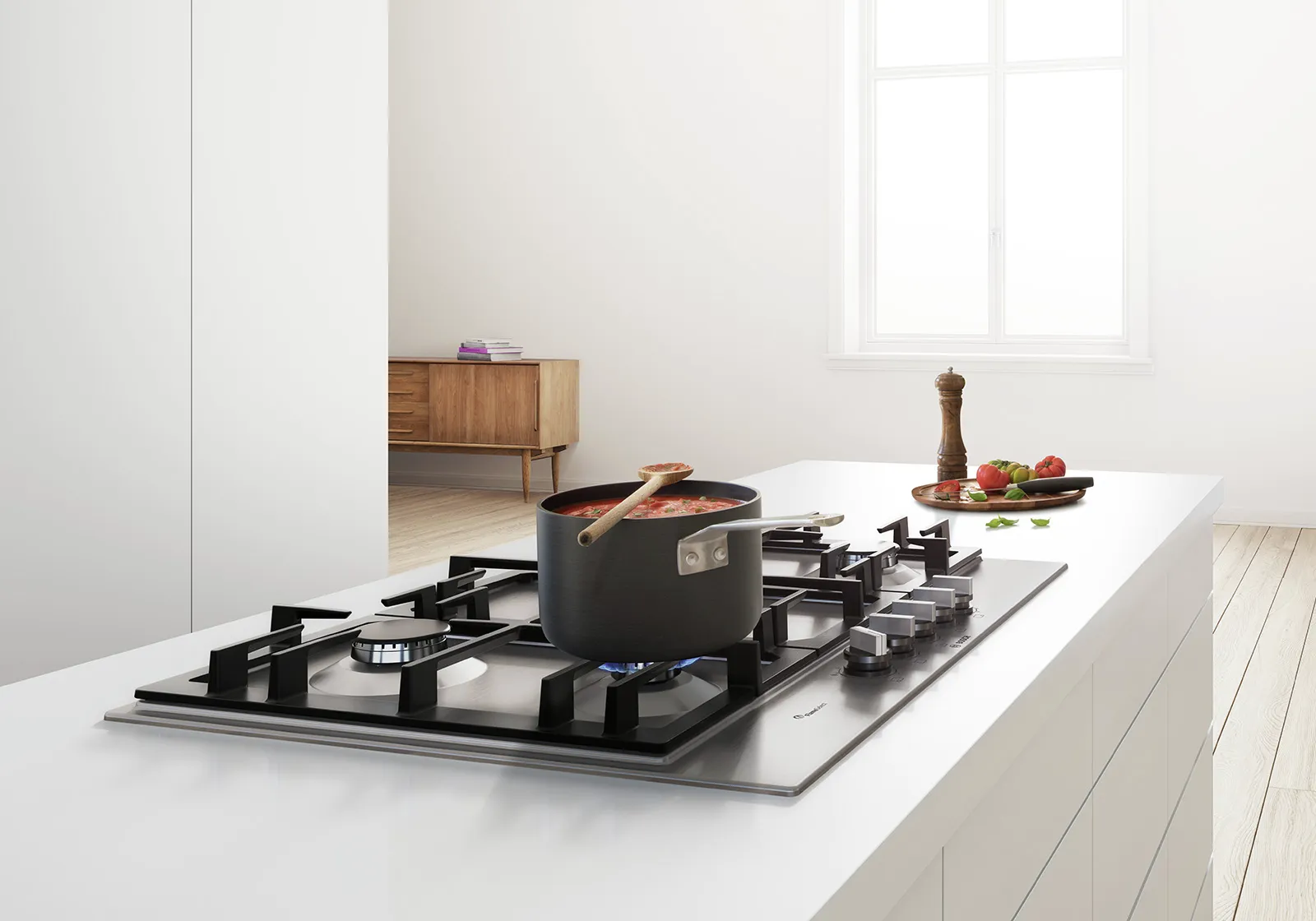 Modern kitchen with gas stove, wooden cabinet, and fresh produce on counter.