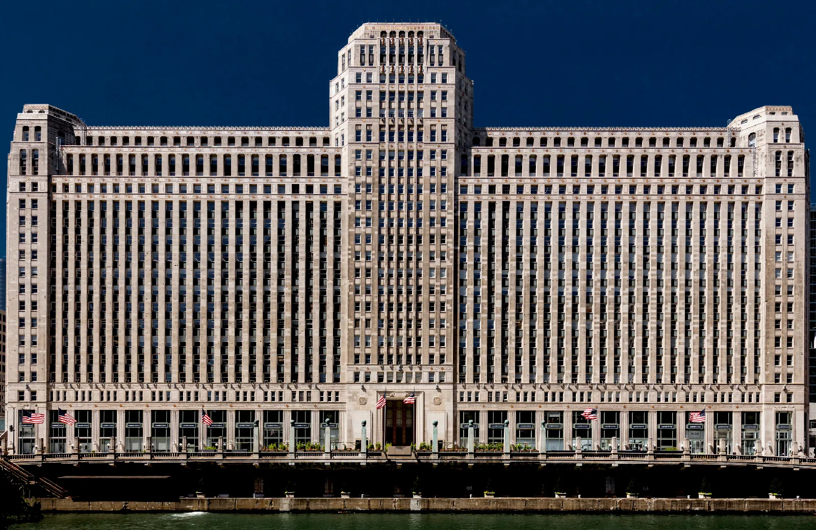 Bosch Chicago building with a symmetrical facade and American flags on display.