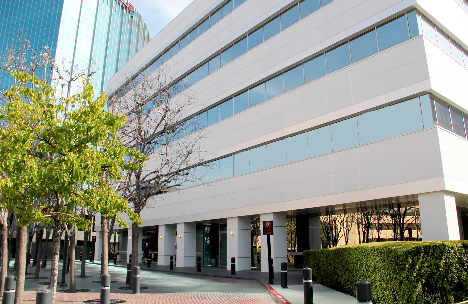 Bosch Irvine office building with large windows, green trees, and clear skies.