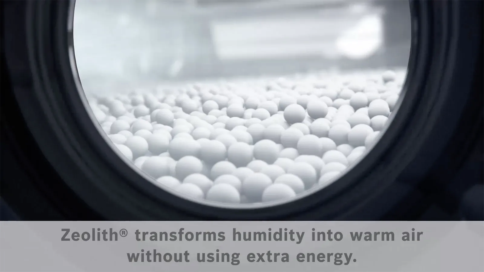 A close-up view of Zeolith mineral pellets inside a dishwasher, with text explaining that "Zeolith® transforms humidity into warm air without using extra energy."