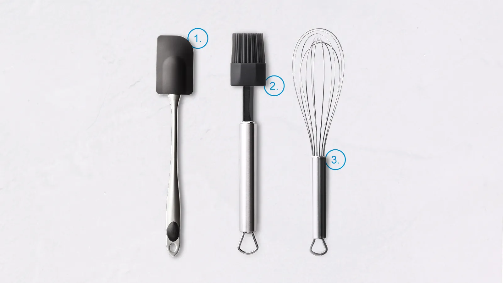 Kitchen utensils: spatula, whisk, and brush on white background.