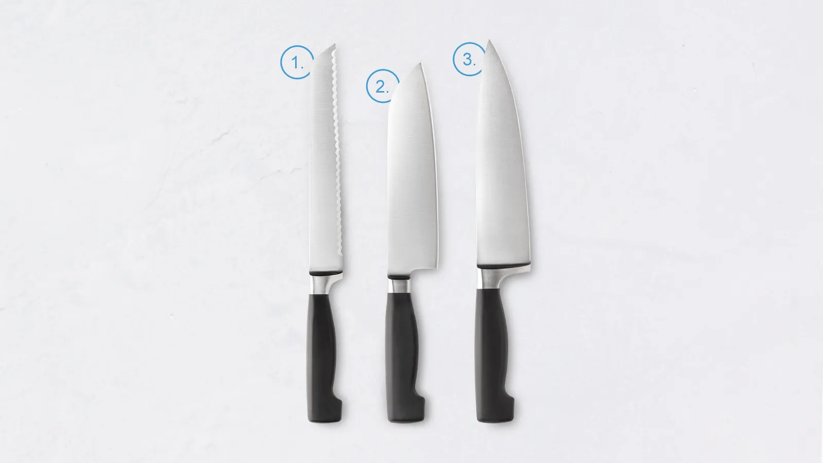 Three white kitchen knives with black handles on a white background.