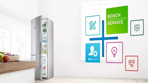 A Bosch refrigerator in a kitchen next to a graphic advertising Bosch Home Appliances Service.