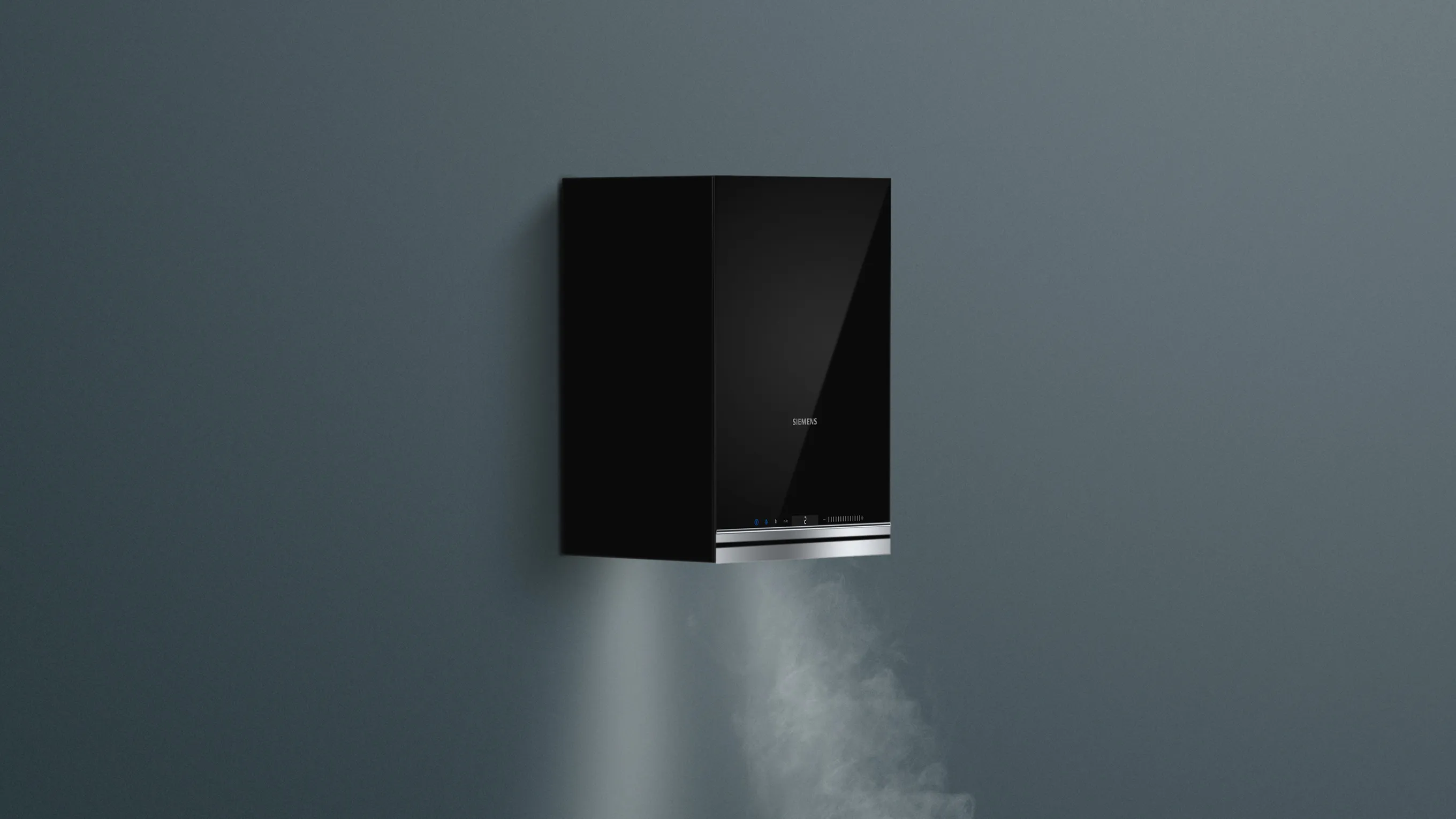 Black rectangular wall-mounted device extracting steam against dark background.