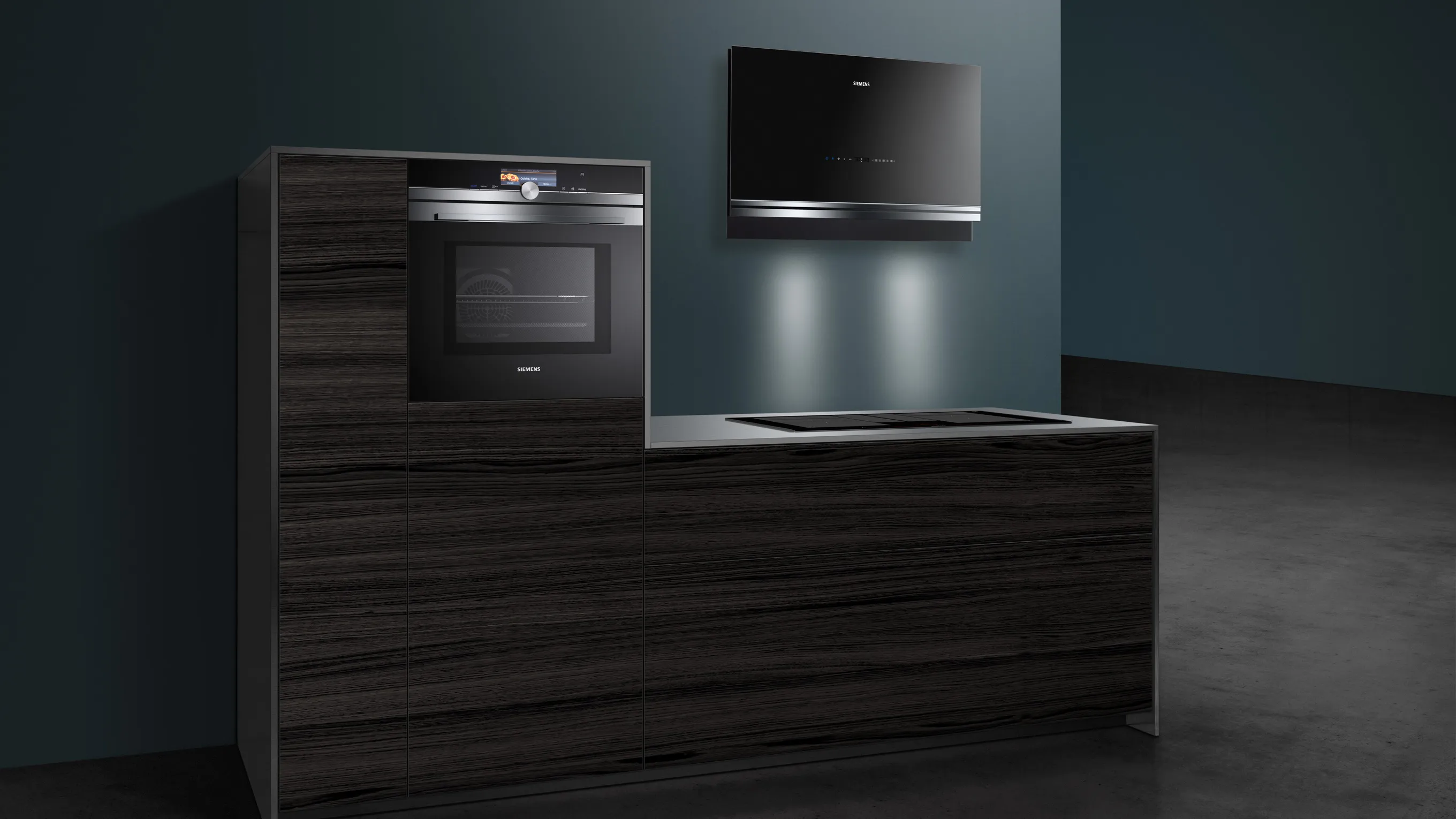 Modern kitchen cabinets, oven, and microwave in dark wood tones against a dark background.