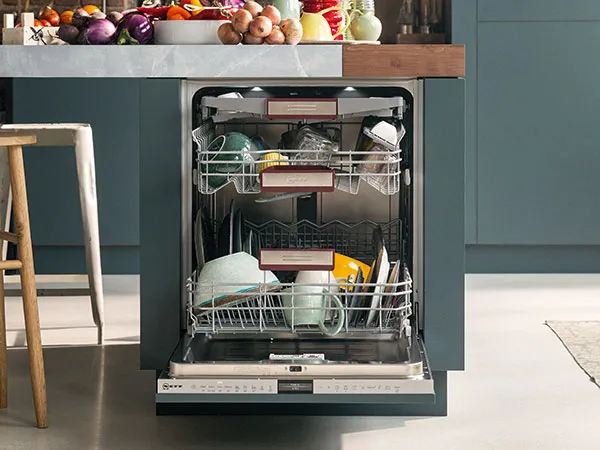 Dishwasher under kitchen island with door down open showing dishes inside