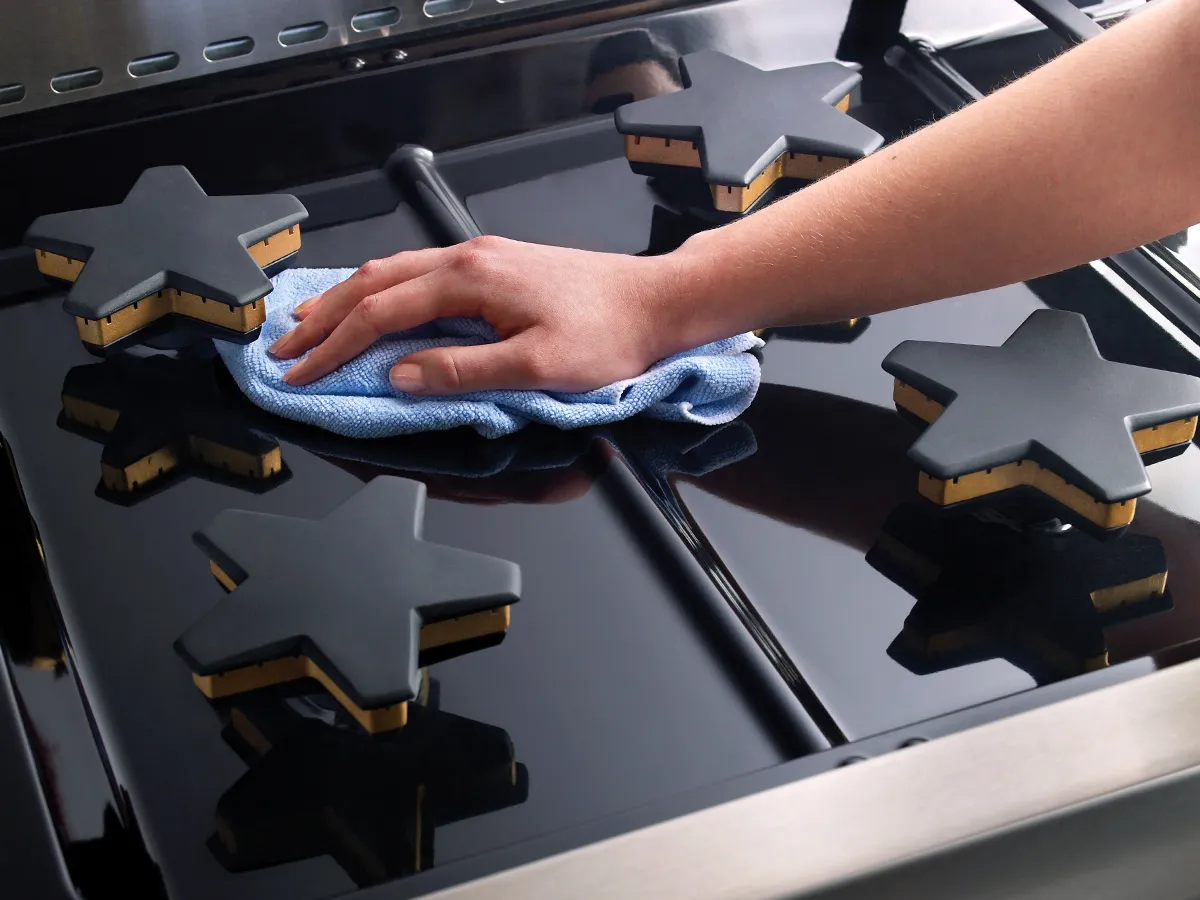 Nettoyage d'une cuisinière avec un chiffon