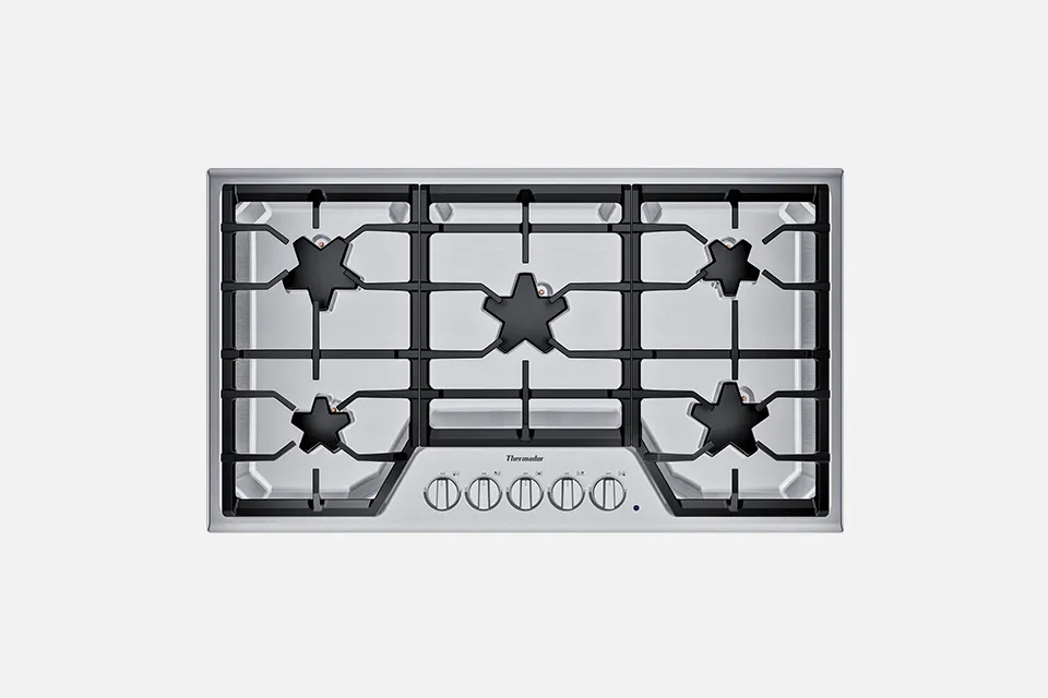 alt-Gas cooktop with 5 burners and star-shaped grates on a stainless steel surface.