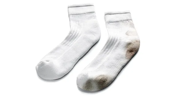 White socks with dirt stains on the toes and heels.