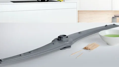 Bosch Dishwasher spray arm on a counter beside a bowl and skewers in a modern kitchen.