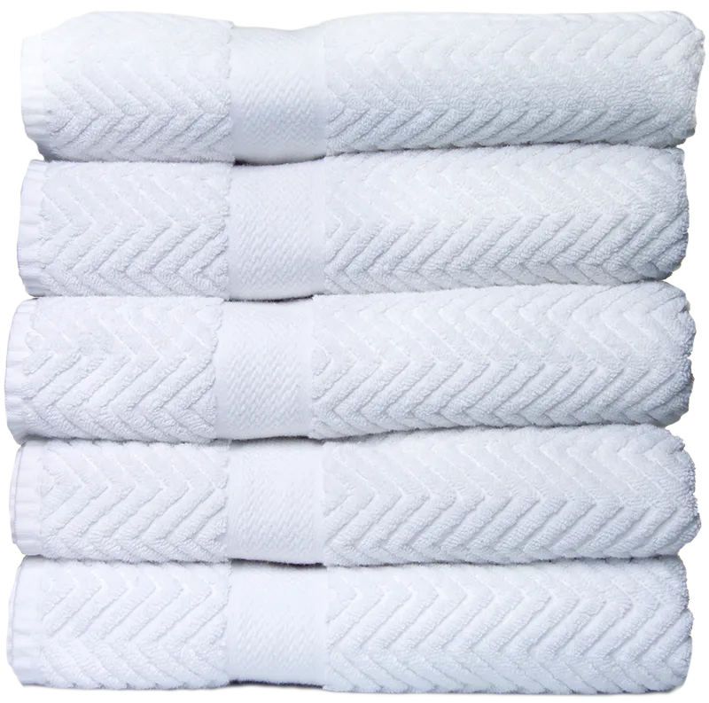 Stack of six white towels with a chevron pattern on the edges