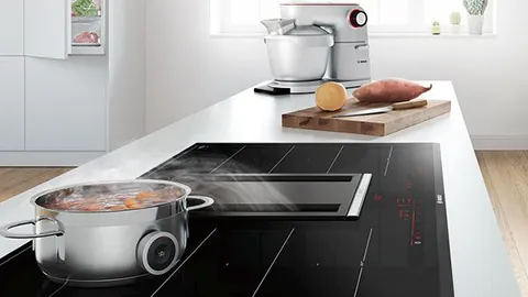 Downdraft hood with pans cooking food