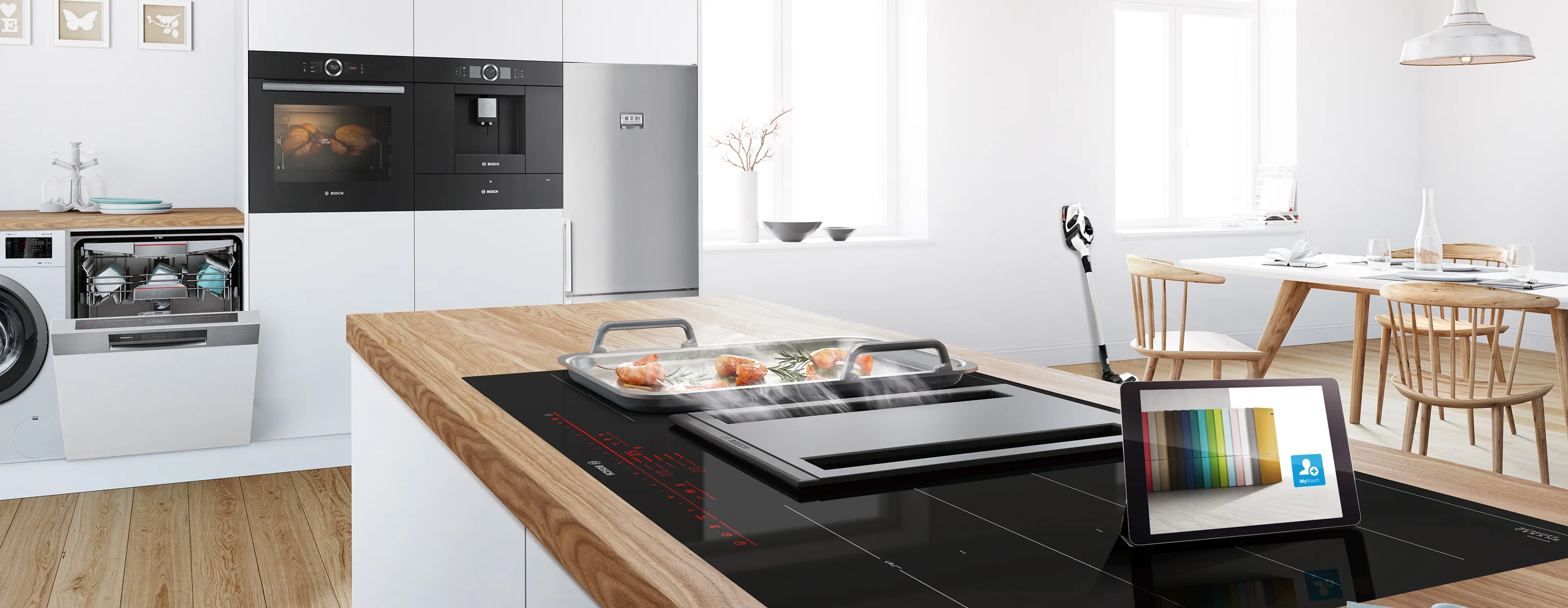 Modern kitchen with appliances, wooden countertop, tablet, and dining area.