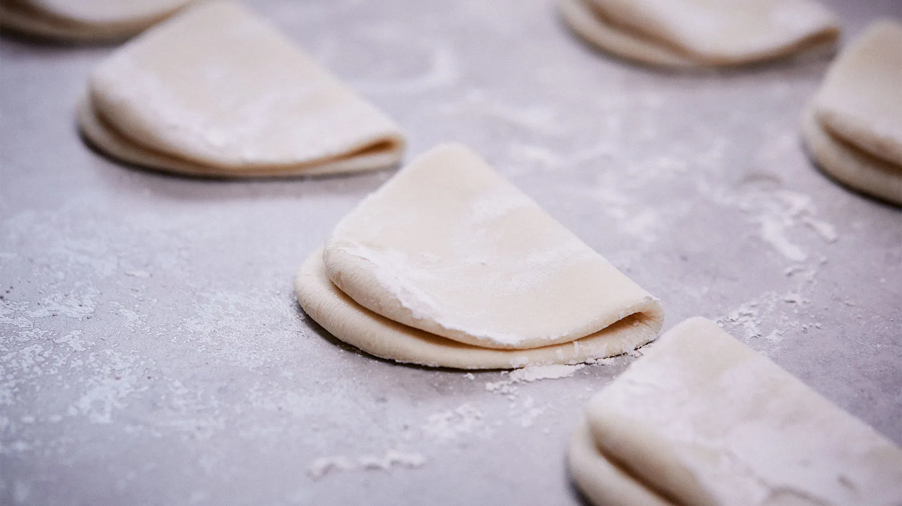 Dough pieces on a floured surface, ready for baking or shaping.