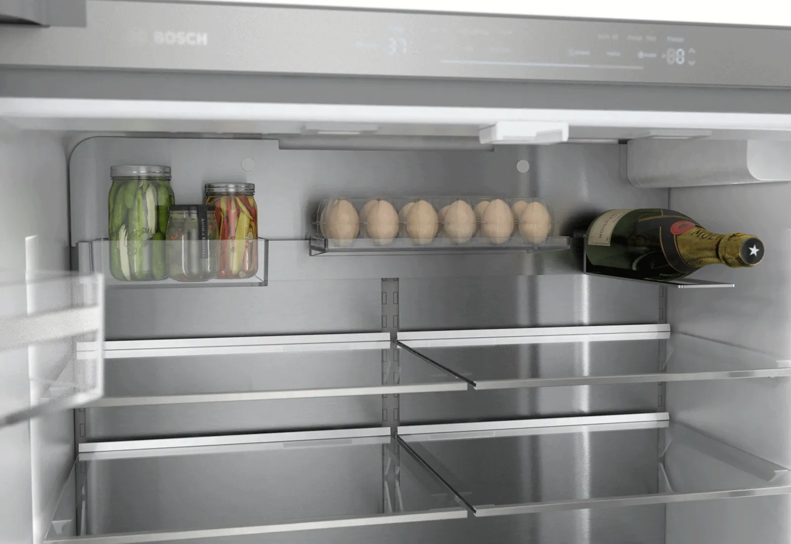 Interior of a Bosch refrigerator with eggs, jars, and a wine bottle on the shelves.