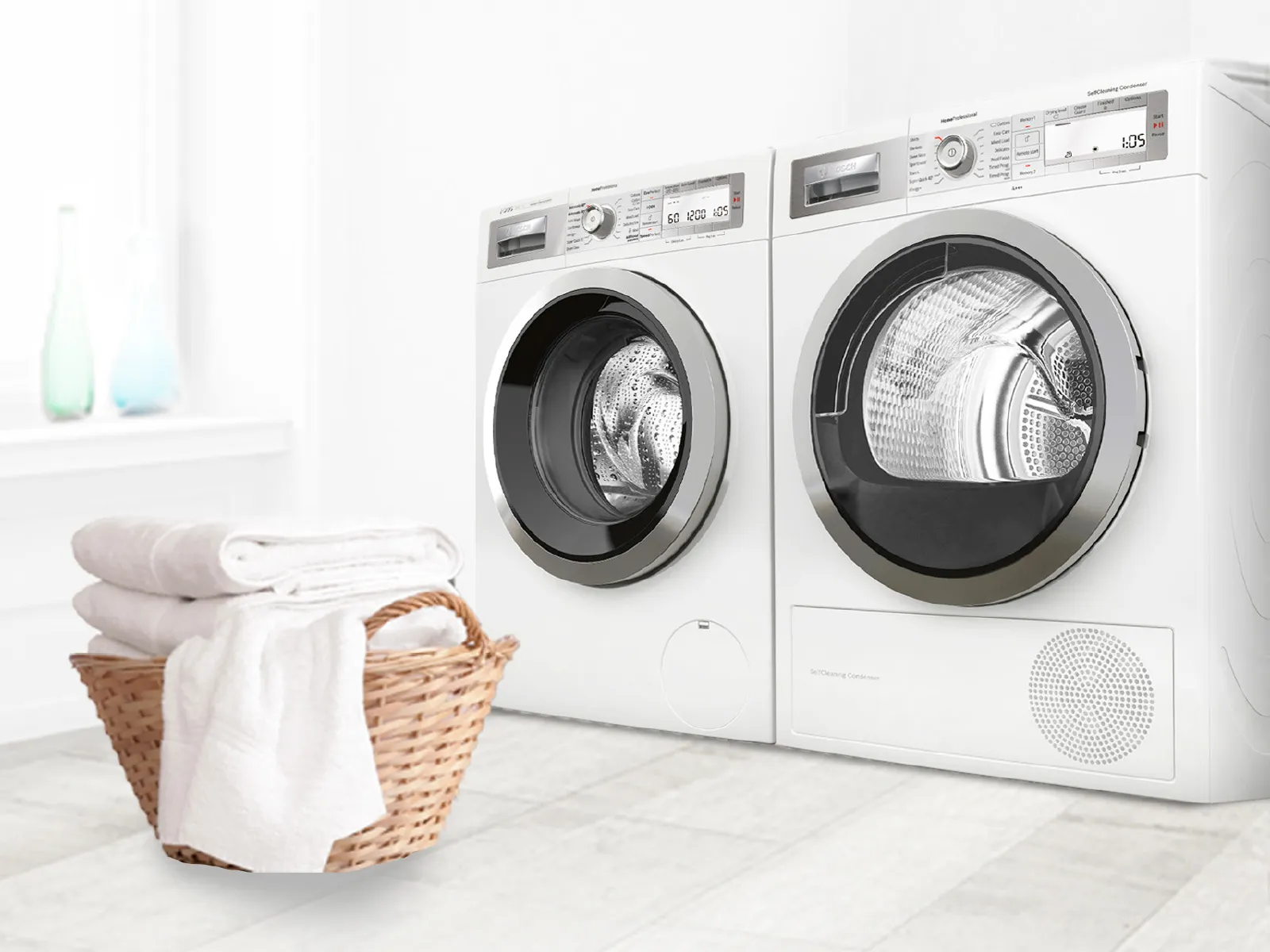 Washing machine and dryer in a laundry room, with a basket of towels nearby.
