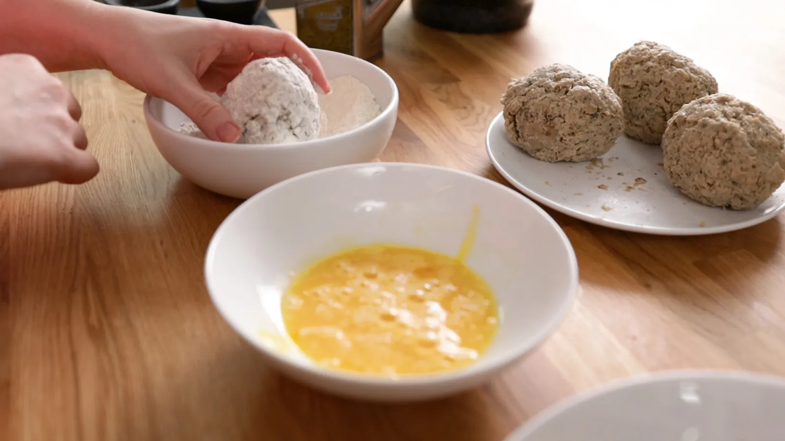 Dipping egg into egg wash mixture