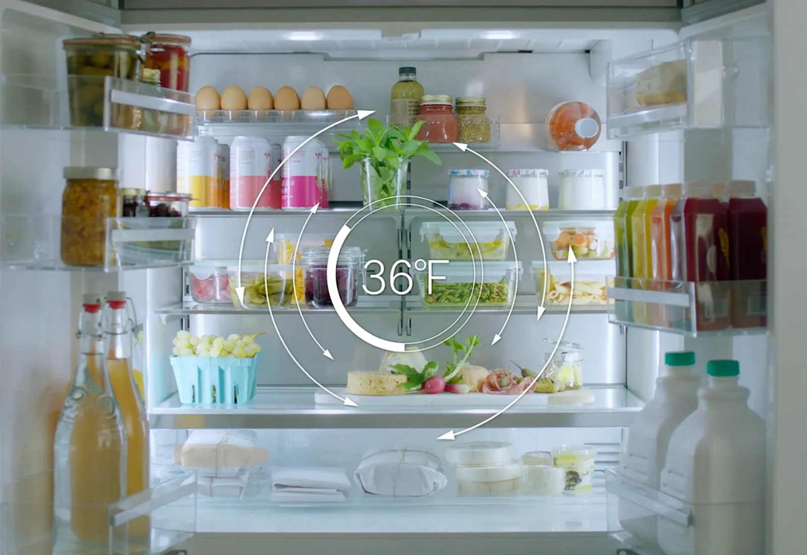 Open Bosch fridge with various food items stored at 36°F, including eggs, drinks, and fresh produce.