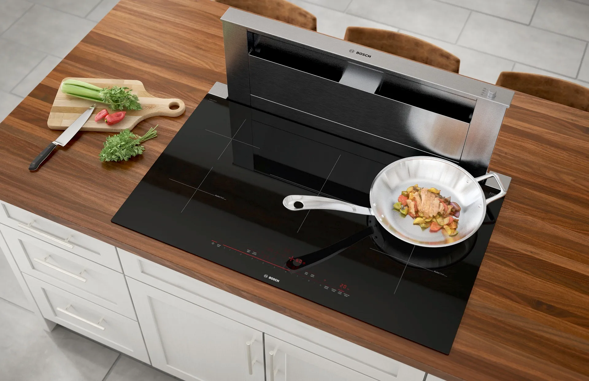 Wooden kitchen countertop with cooking utensils, Bosch induction cooktop, and a plate of prepared food.