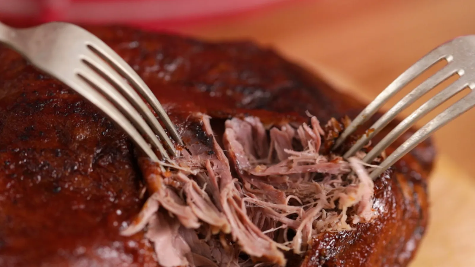Person shredding duck with forks