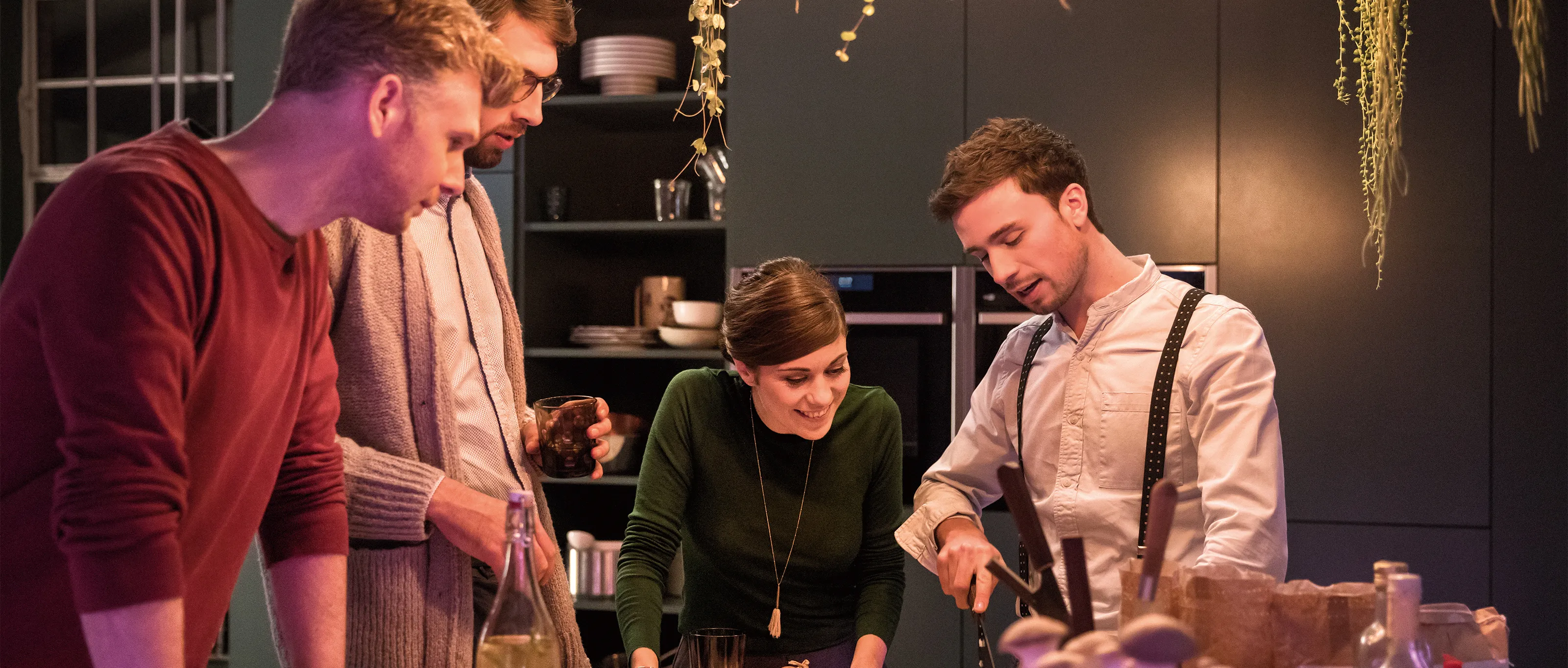 Friends enjoying cooking together with NEFF appliances