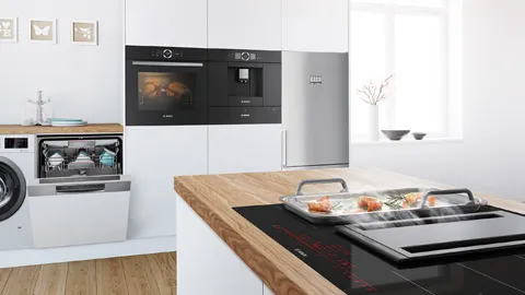Kitchen with white cabinets with Bosch appliances