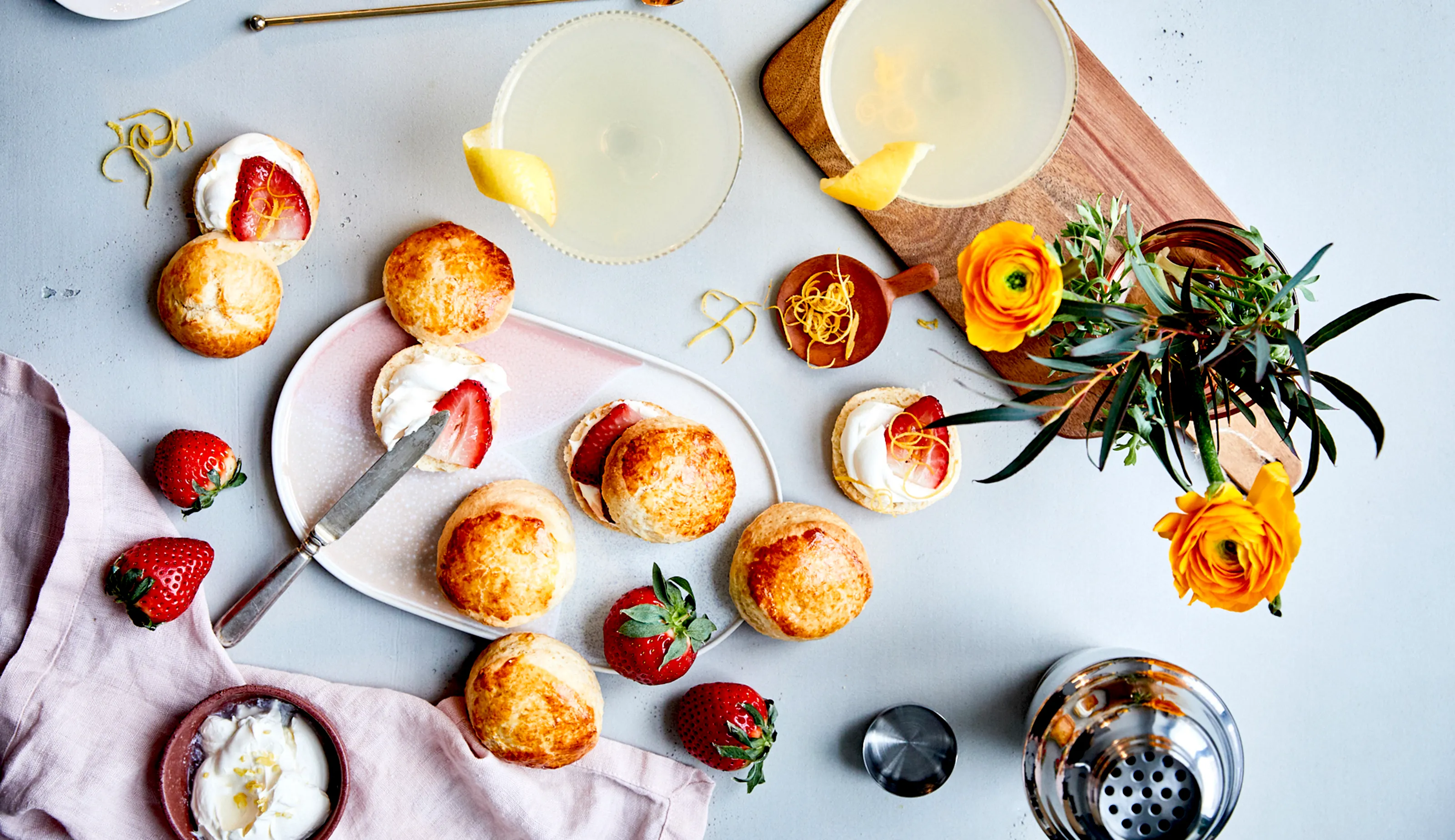 Vanilla scones on a plate on table with cutlery and utensils in background