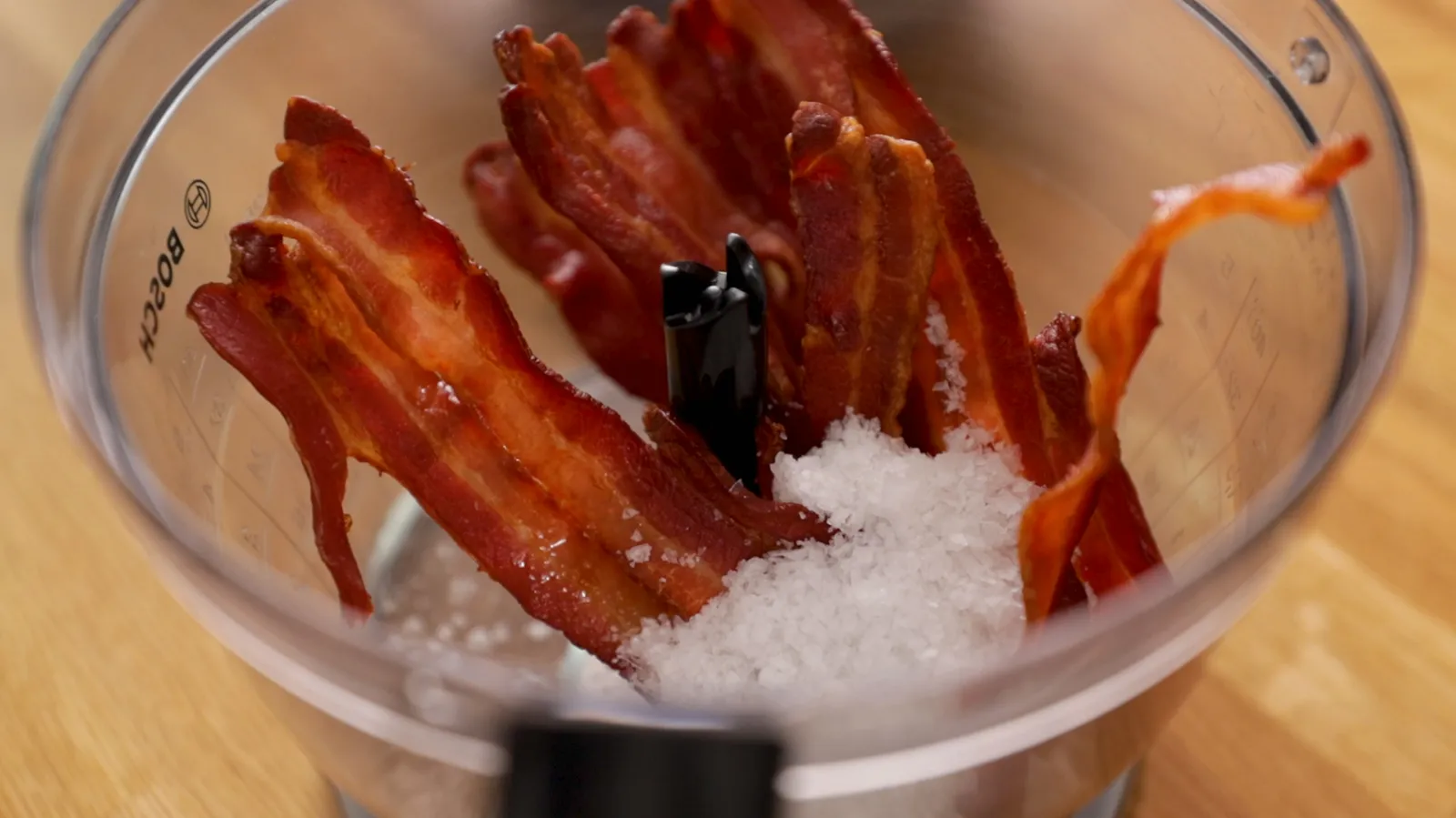 cooked bacon in a bowl with salt and pepper