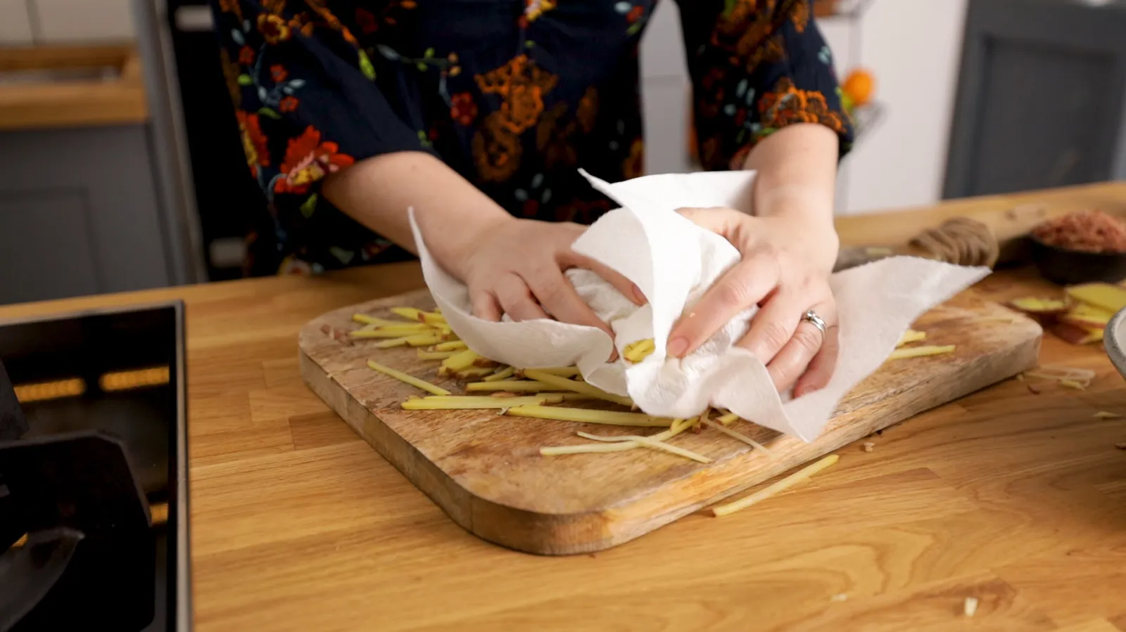 Person patting fries dry