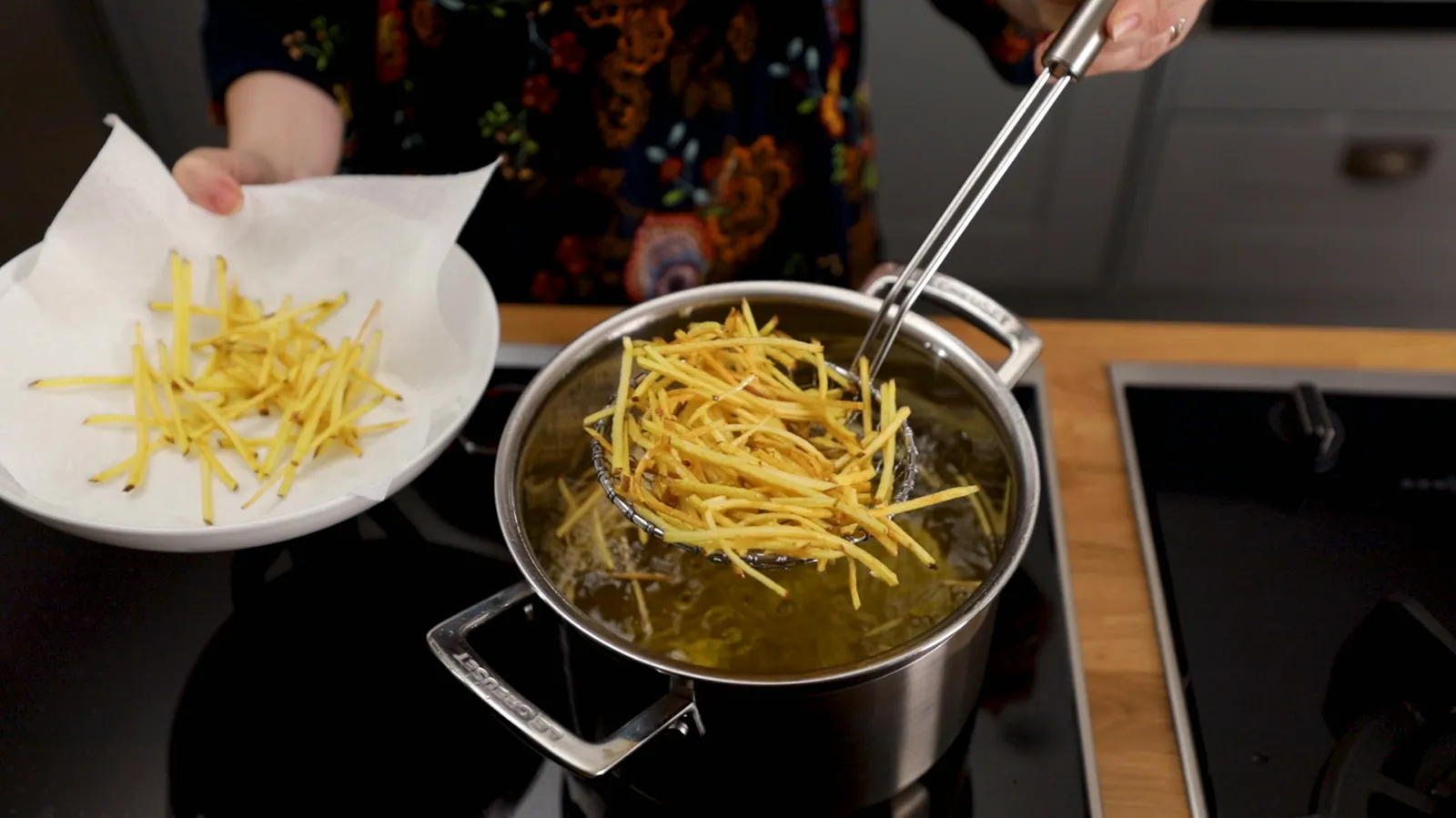 Person taking fries out of fryer